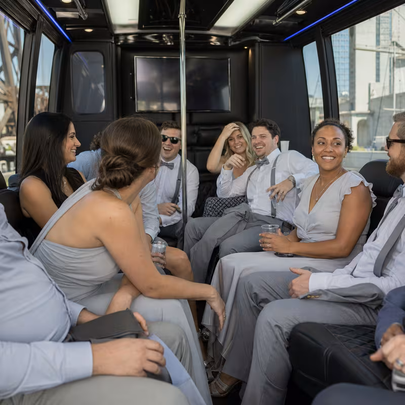 Wedding guests seated inside a Cleveland party bus