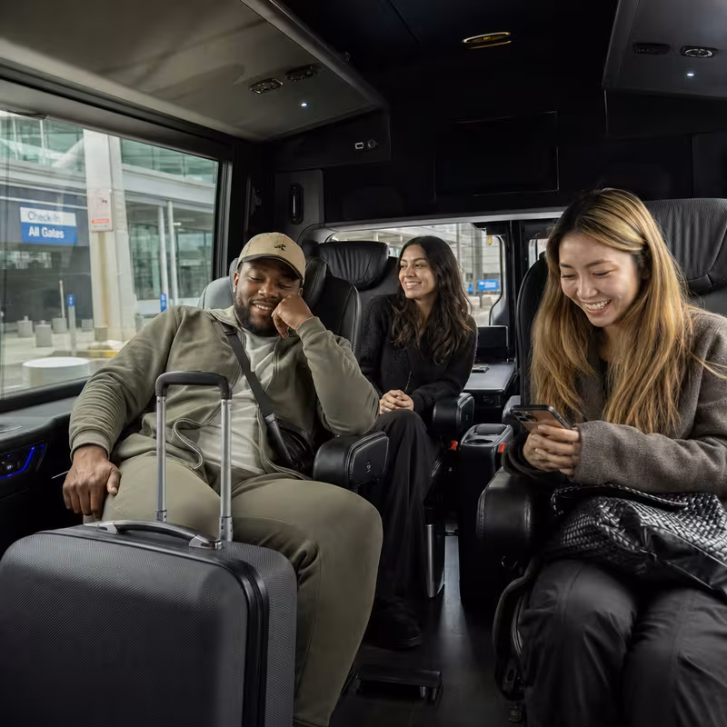 Passengers loading luggage while boarding an Cleveland group shuttle