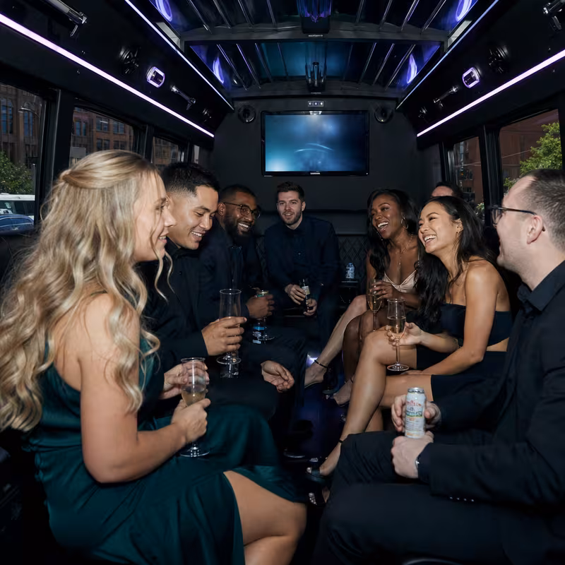 Party bus interior with wraparound leather seating and LED lighting in Cleveland