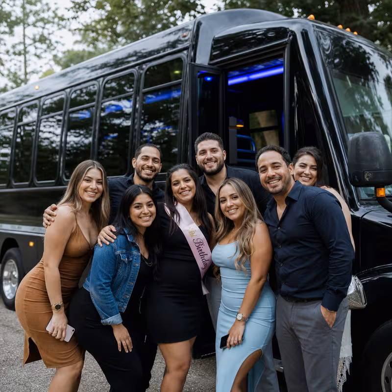 Group boarding a white charter bus for Birthday Transportation transportation in Cleveland