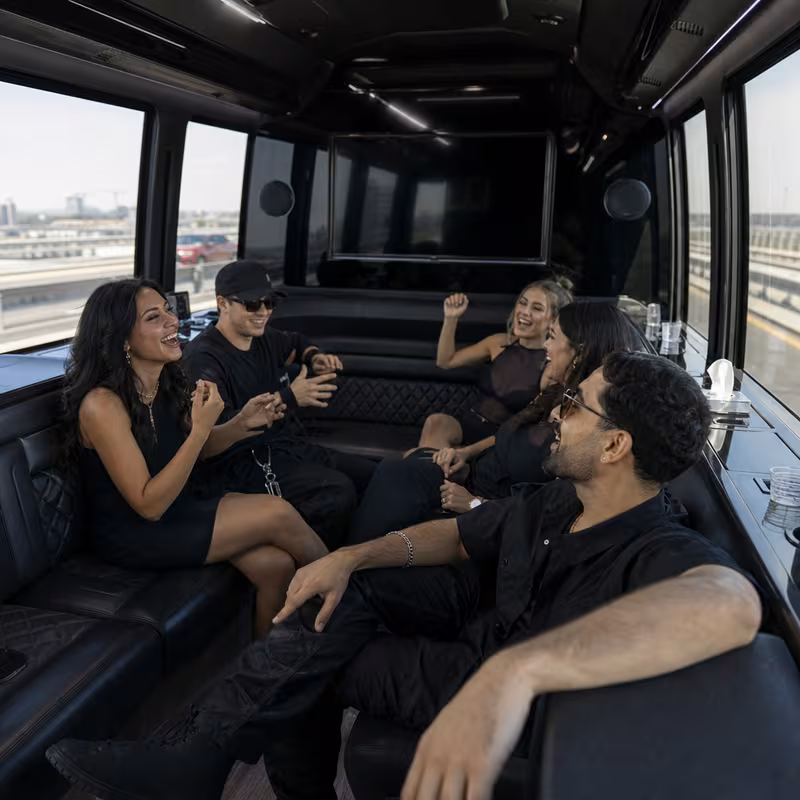 Group boarding a white charter bus for Concert Transportation transportation in Cleveland