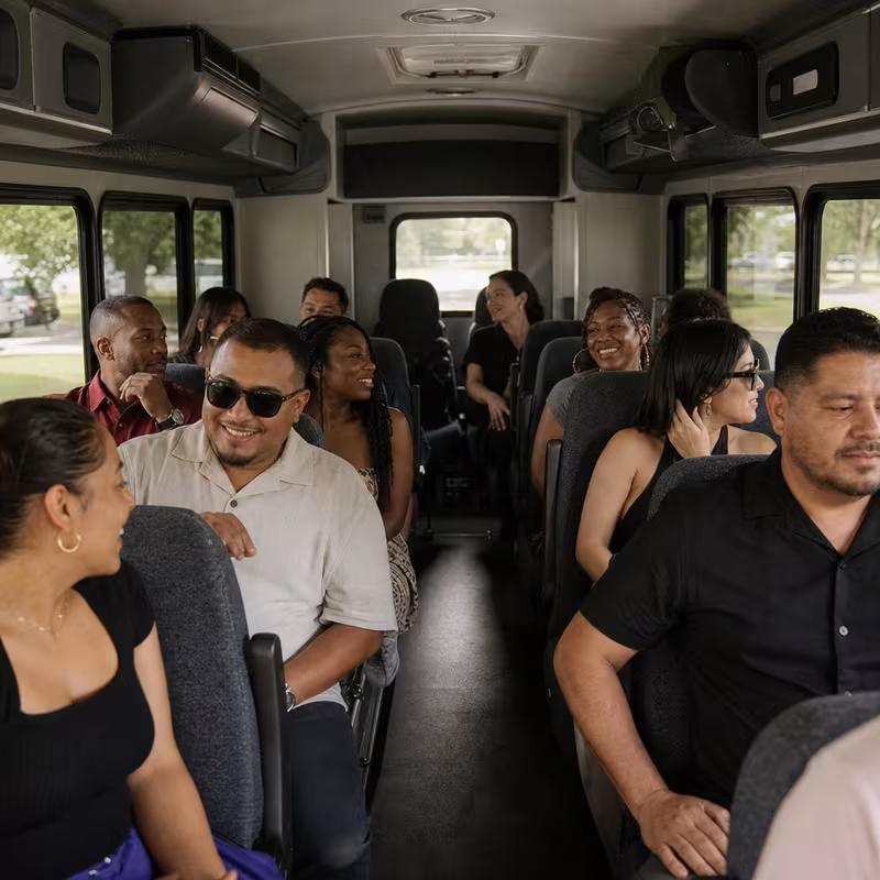Group boarding a white charter bus for Private Event Transportation transportation in Cleveland