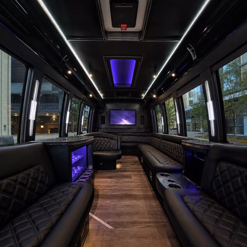 Party bus interior with wraparound leather seating and LED lighting in Cleveland