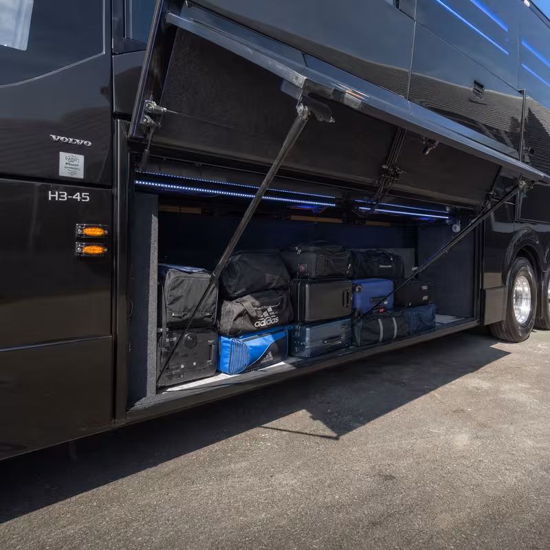 Party bus interior with wraparound leather seating and LED lighting in Cleveland